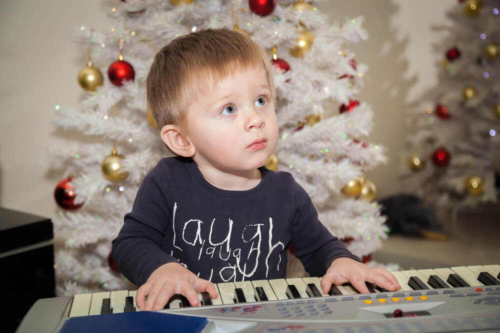 bambino che suona una tastiera a natale